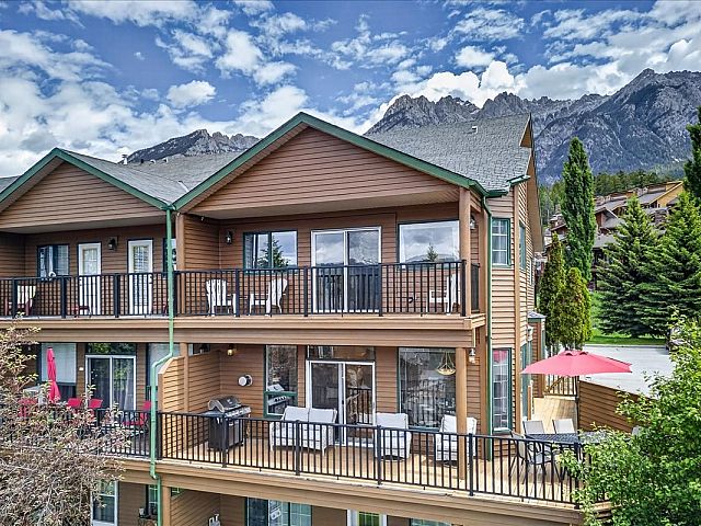 Exterior of Marble Canyon 704 Phase 2 showcasing the large deck, private balconies, and stunning mountain views in Fairmont Hot Springs.