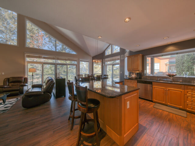 Kitchen area with modern appliances, cooking space, and windows.
