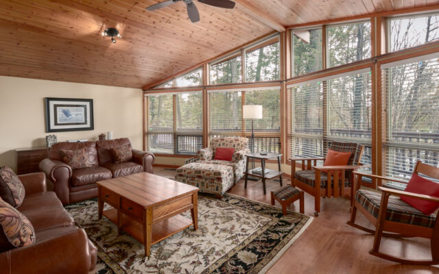 Large cabin with open concept. Surrounded by greenery and trees.